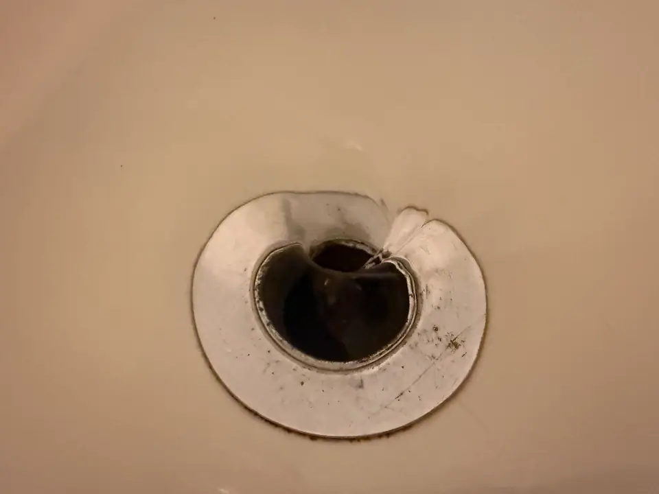 Agua girando en remolino al irse por el desagüe de una bañera